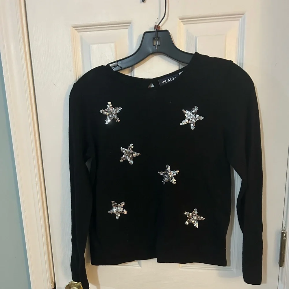 The children’s place black sweater with sequins stars.